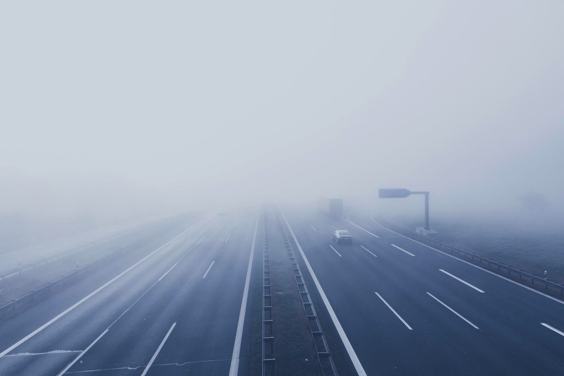 Europæisk motorvej i tæt tåge med en lastbil forude